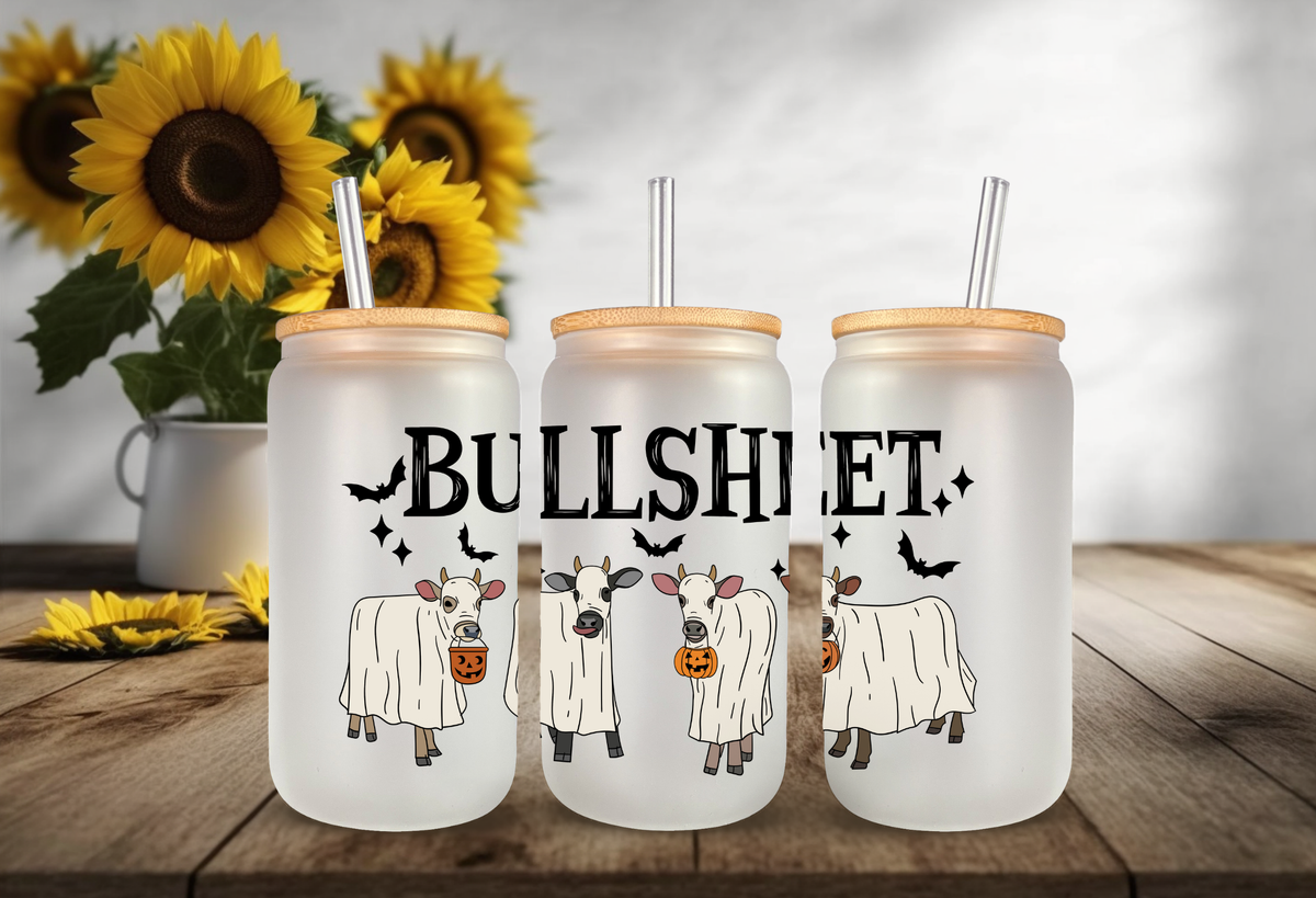 mock up of 16oz frosted glass tumbler mockup featuring three ghost-costumed cows with pumpkin buckets and "BULLSHEET" text.