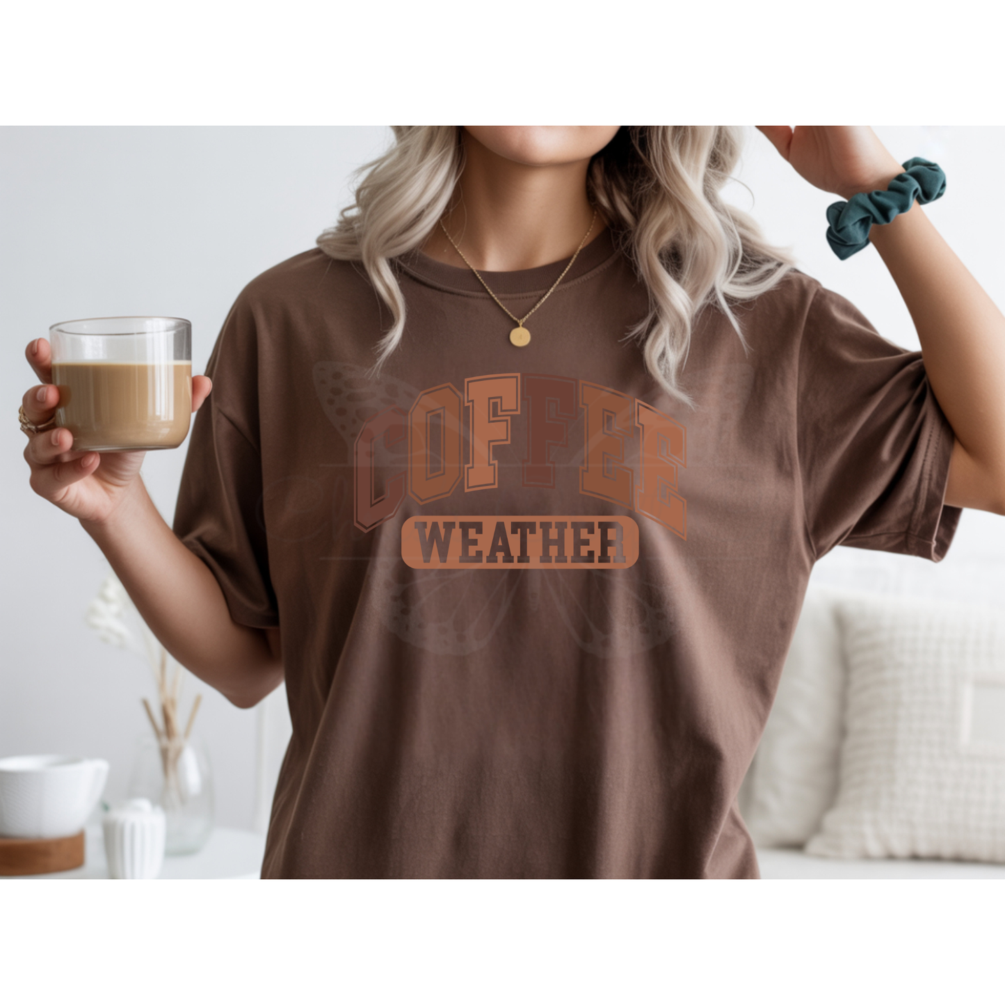 A mock up of a brownn shirt with wording "coffee weather" wording design.