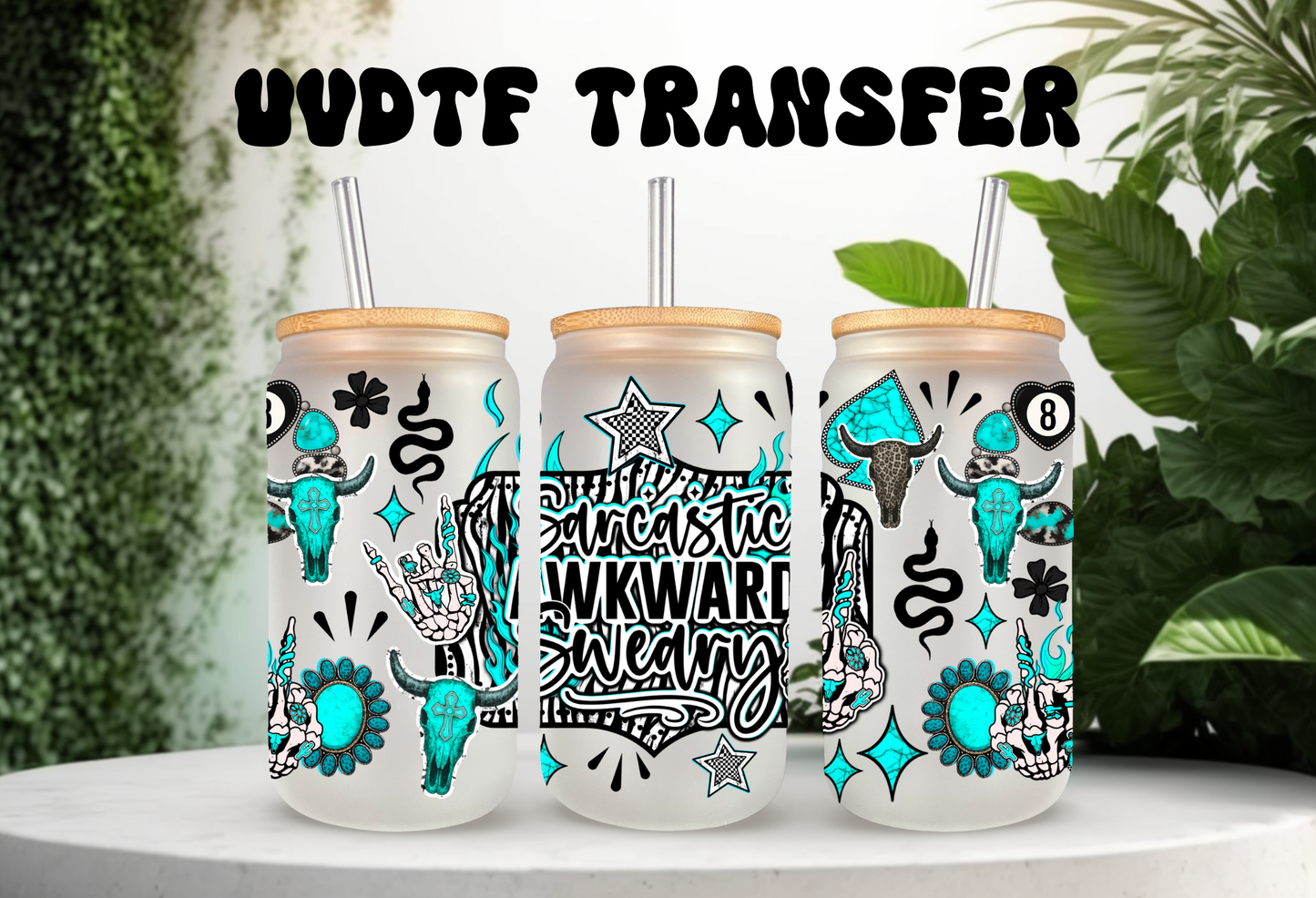 A UVDTF glass can wrap mockup showing three 16oz frosted glass cans. The design features a Western turquoise theme with the text "Sarcastic Awkward Sweary." The graphic includes cow skulls with turquoise stones, black stars, and lightning bolts. The cans are topped with bamboo lids and straws, set against a white background with green plants