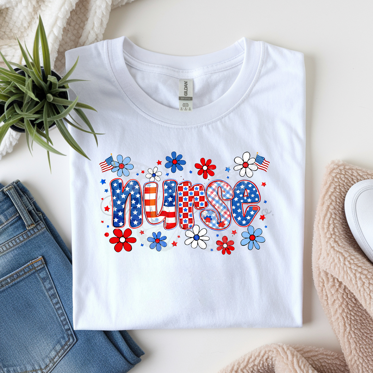 mock up of a White t-shirt with 'NURSE' design featuring American flags and flowers on a light surface.