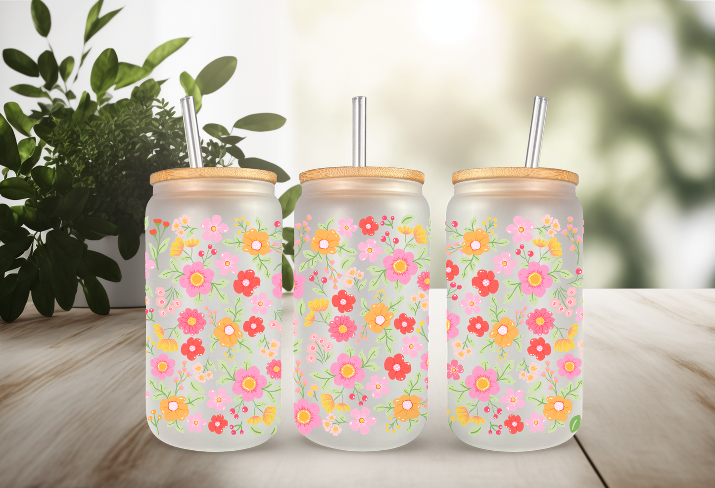 MOCKUP OF A 16oz frosted can glass wrap featuring a retro groovy floral design with bright pink, red, and yellow daisies on a clear background.
