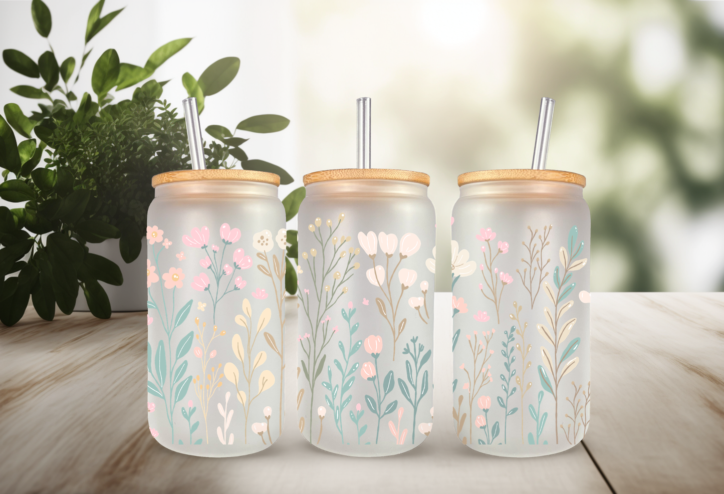 Mockup of 16oz can glass wrap featuring delicate pastel wildflowers, pink daisies, blue blossoms, and green leaves on a clear background.