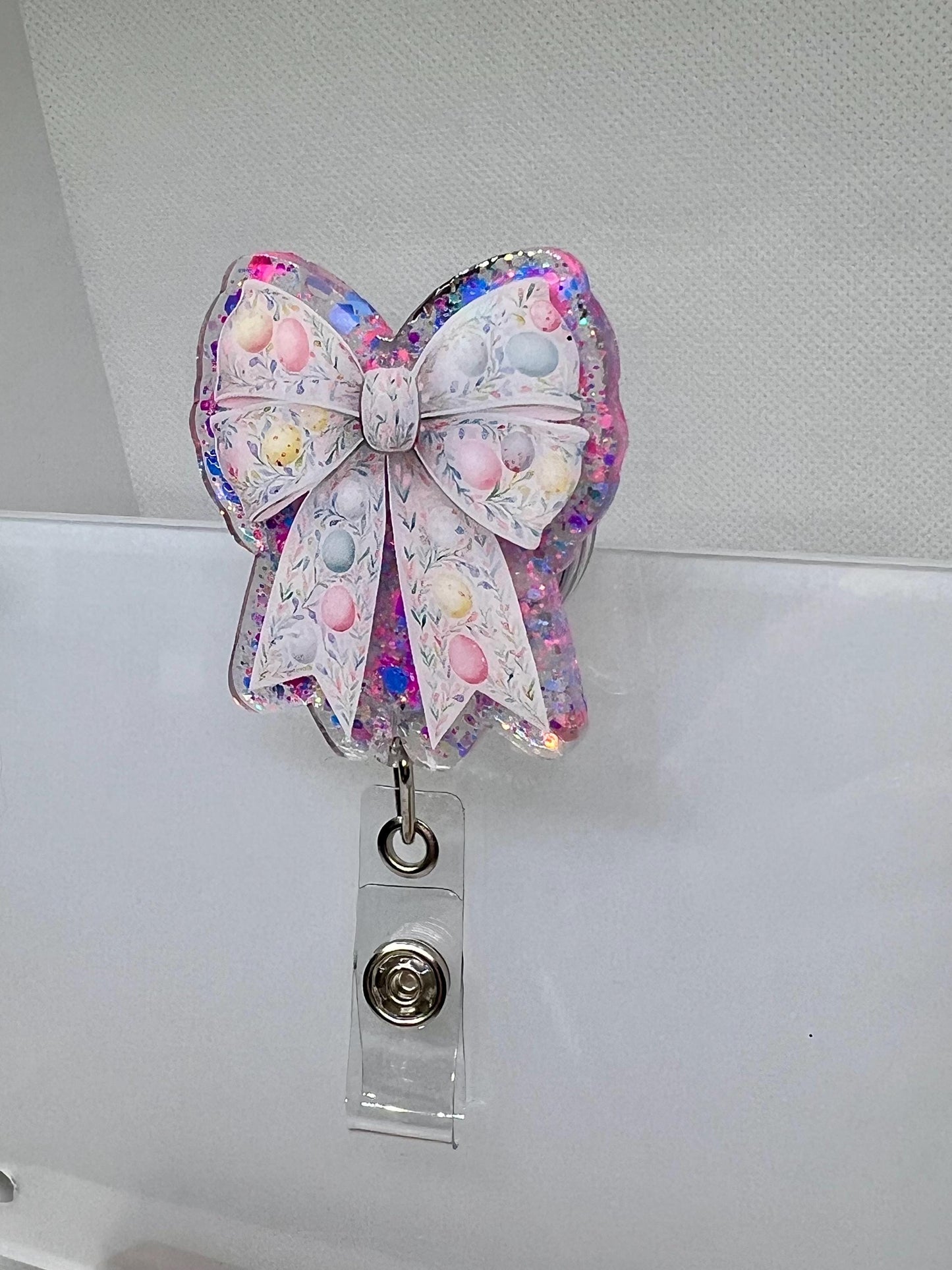Glittery Easter Bow Badge Reel – Pastel Egg and Floral Design for Nurses, Teachers, and Professionals