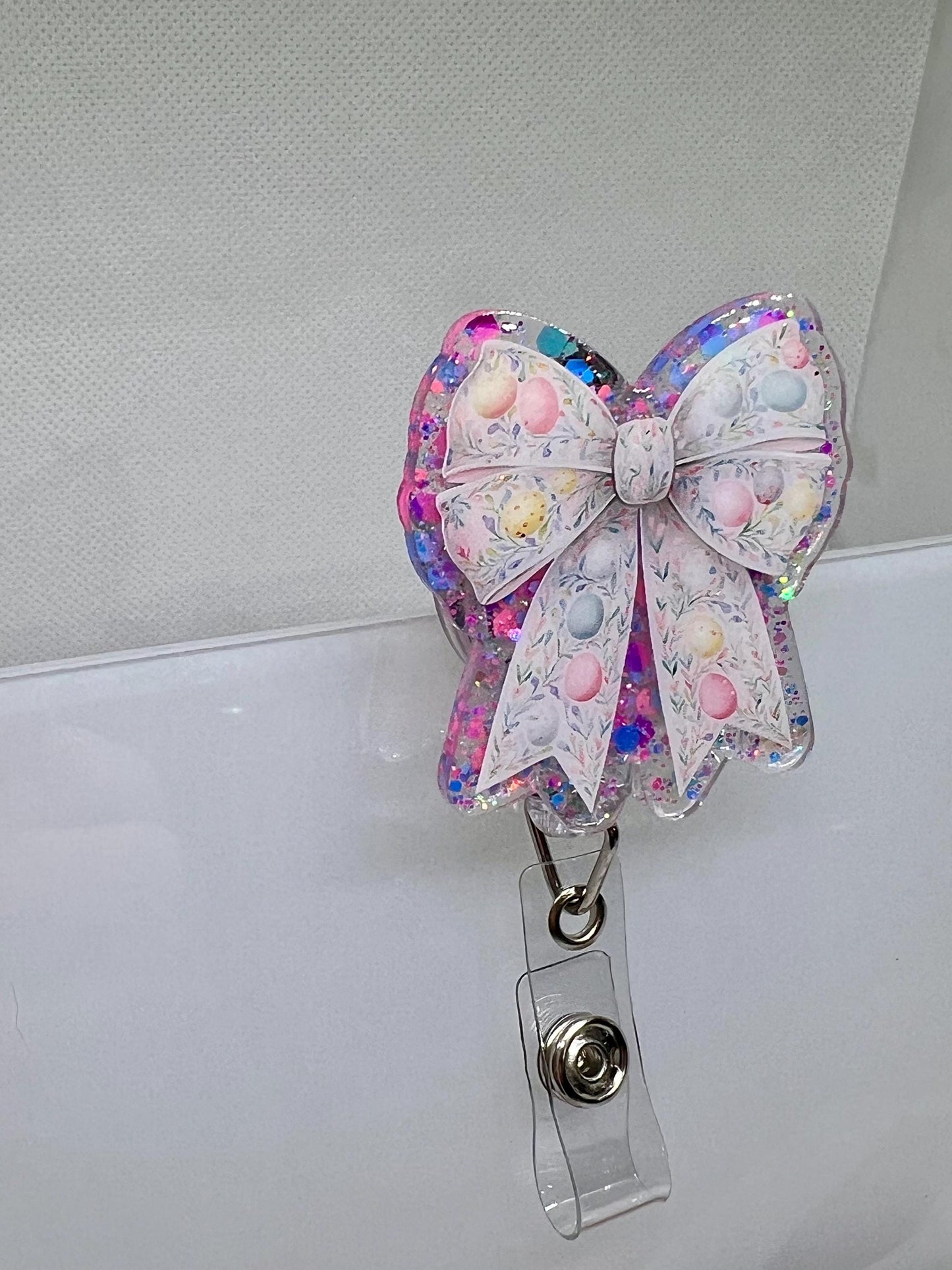 Glittery Easter Bow Badge Reel – Pastel Egg and Floral Design for Nurses, Teachers, and Professionals