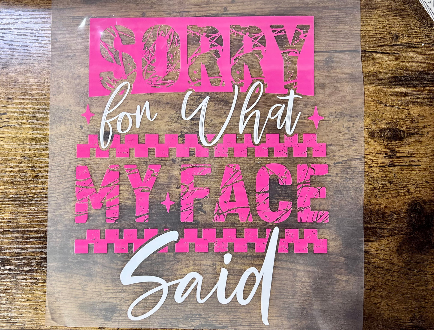 Sassy pink and white typography DTF transfer featuring the phrase "Sorry For What My Face Said" for ready-to-press boutique shirts.
