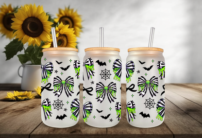Spooky coquette UV DTF wrap featuring neon green slime drips, black and green spiderweb bows, bats, and cobwebs for 16oz glass can tumblers.