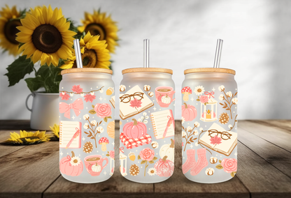 Cozy pink bookish autumn UV DTF wrap featuring reading glasses, open books, pink pumpkins, coffee mugs, and autumn foliage for 16oz glass can tumblers.