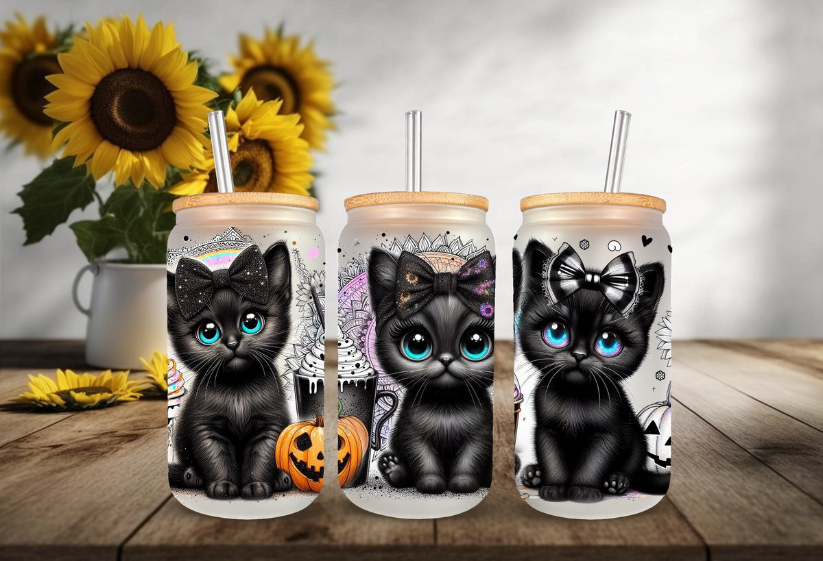 16oz frosted glass tumbler mockup featuring three adorable black kittens with big glossy eyes, witch hats, and jack-o-lanterns on a clear background.
