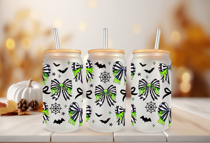 Spooky coquette UV DTF wrap featuring neon green slime drips, black and green spiderweb bows, bats, and cobwebs for 16oz glass can tumblers.