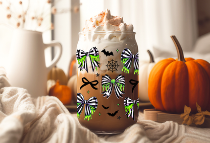 Spooky coquette UV DTF wrap featuring neon green slime drips, black and green spiderweb bows, bats, and cobwebs for 16oz glass can tumblers.