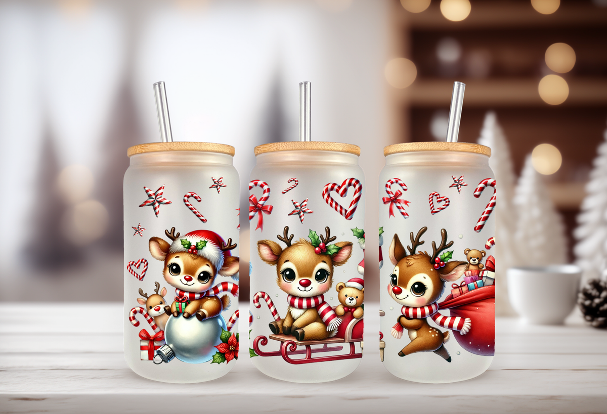Mockup Three 16oz glass can tumblers with bamboo lids and straws displaying colorful holiday reindeer UVDTF wrap designs