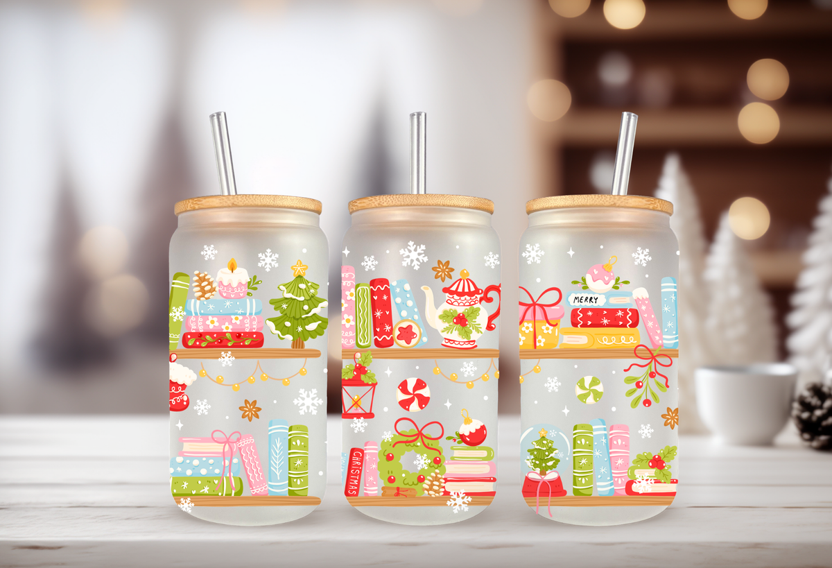 A MOCKUP OF three 16oz glass can tumblers with bamboo lids displaying Christmas books, cozy mugs, and holiday tree UVDTF wrap designs