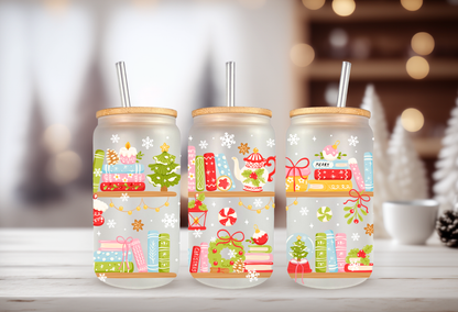 A MOCKUP OF three 16oz glass can tumblers with bamboo lids displaying Christmas books, cozy mugs, and holiday tree UVDTF wrap designs