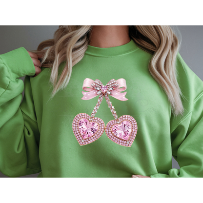 A mock up of a Green sweatshirt with pink heart faux rhinestone and bow design.