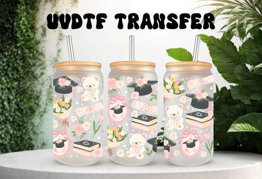 16oz can glass wrap featuring teddy bears in graduation caps, diplomas, stacks of books, pink coquette bows, and spring flowers on a clear background.