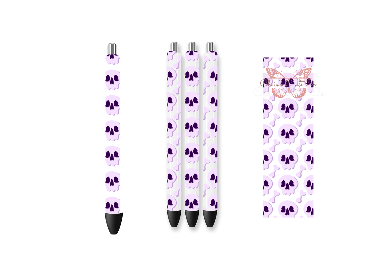 Pen wrap mockup featuring three white gel pens decorated with pastel purple skulls and bones UV DTF transfers.