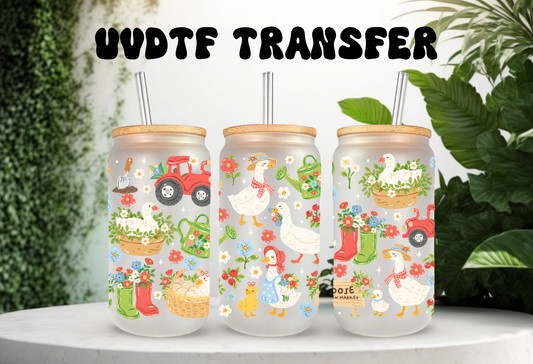 16oz can glass wrap featuring white geese in floral bonnets with a red tractor, garden boots, and flowers on a clear background.