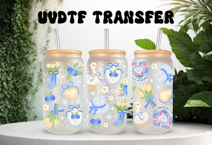 16oz can glass wrap featuring a pastel spring design with white porch geese wearing blue coquette bows mixed with yellow tulips and scattered blueberries.


