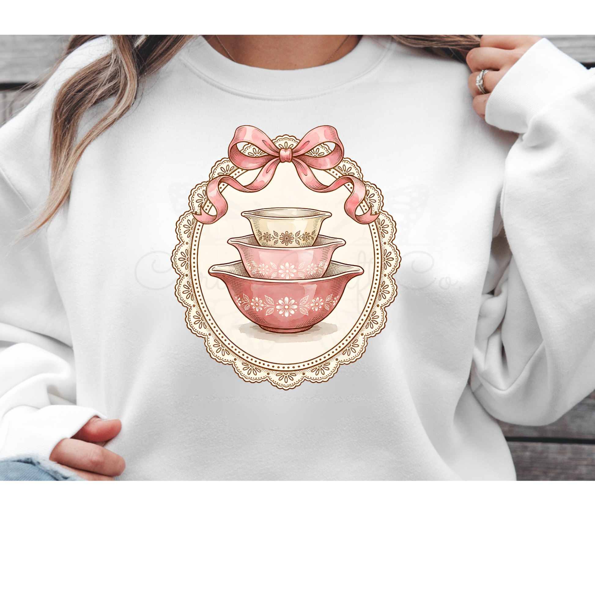 Direct to Film (DTF) transfer design featuring a vintage stack of blue and white nesting mixing bowls topped with a pink coquette bow and framed by a white lace border