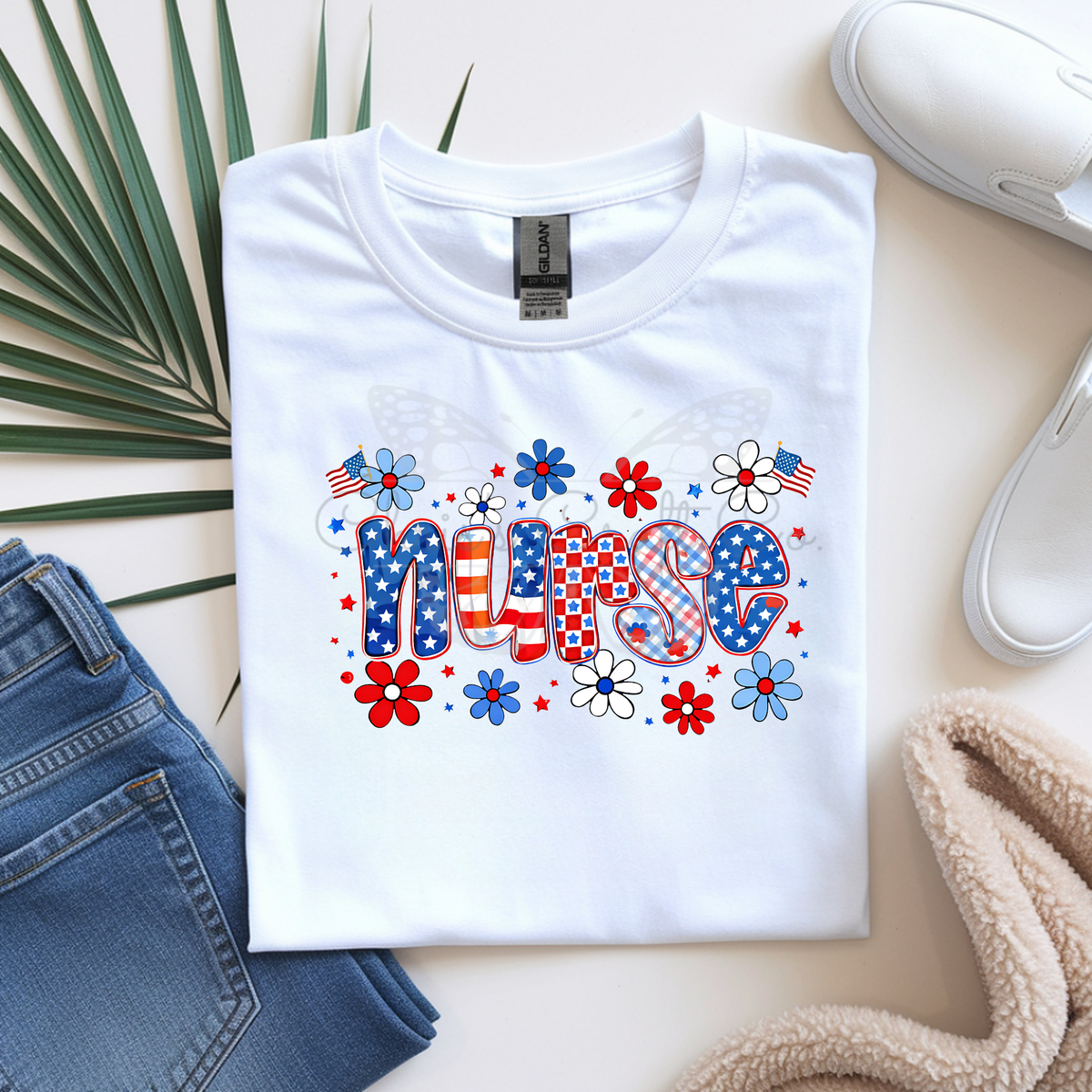 mock up of a White t-shirt with 'NURSE' design featuring stars, flowers, and American flags on a light surface.