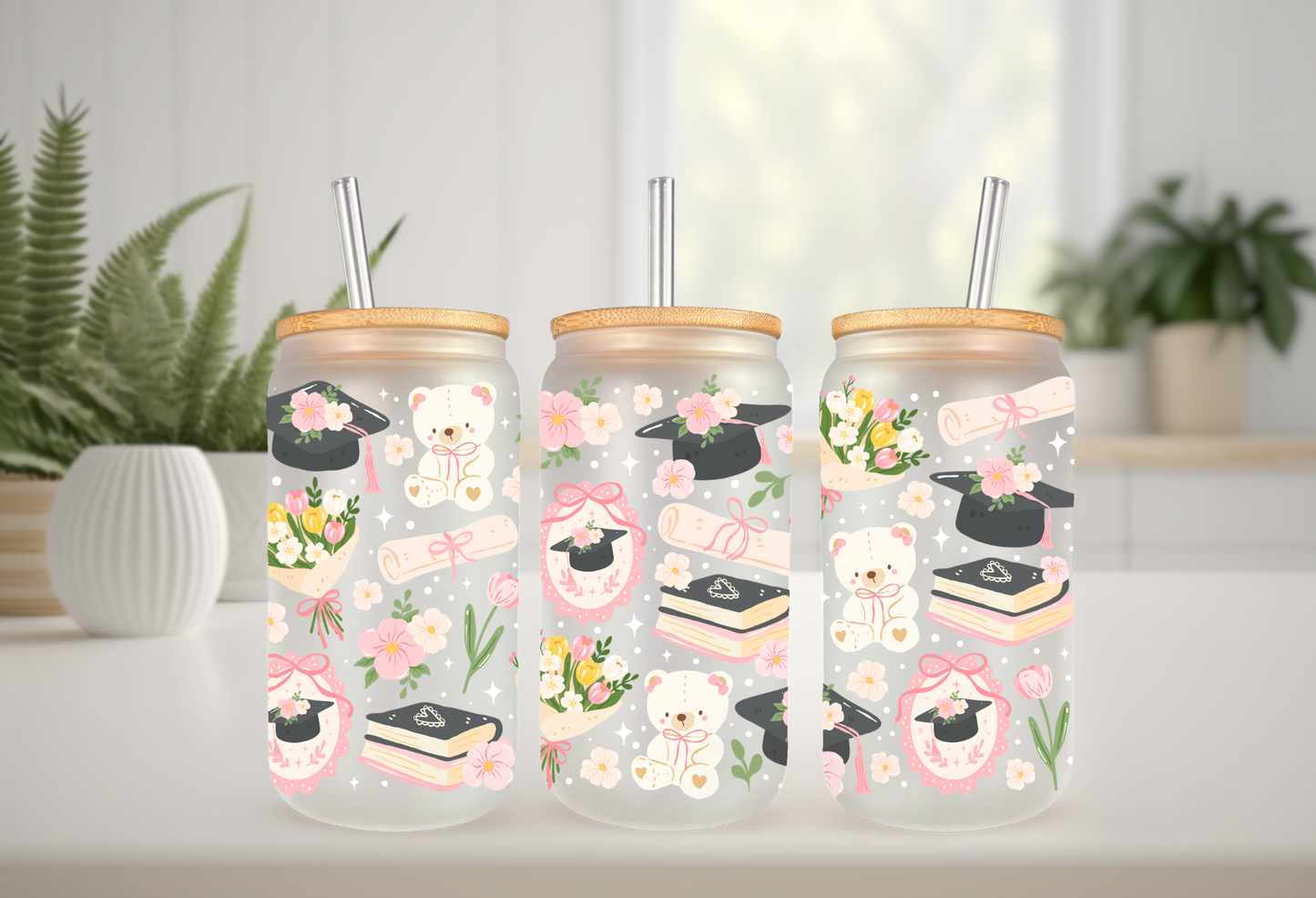 16oz can glass wrap featuring teddy bears in graduation caps, diplomas, stacks of books, pink coquette bows, and spring flowers on a clear background.