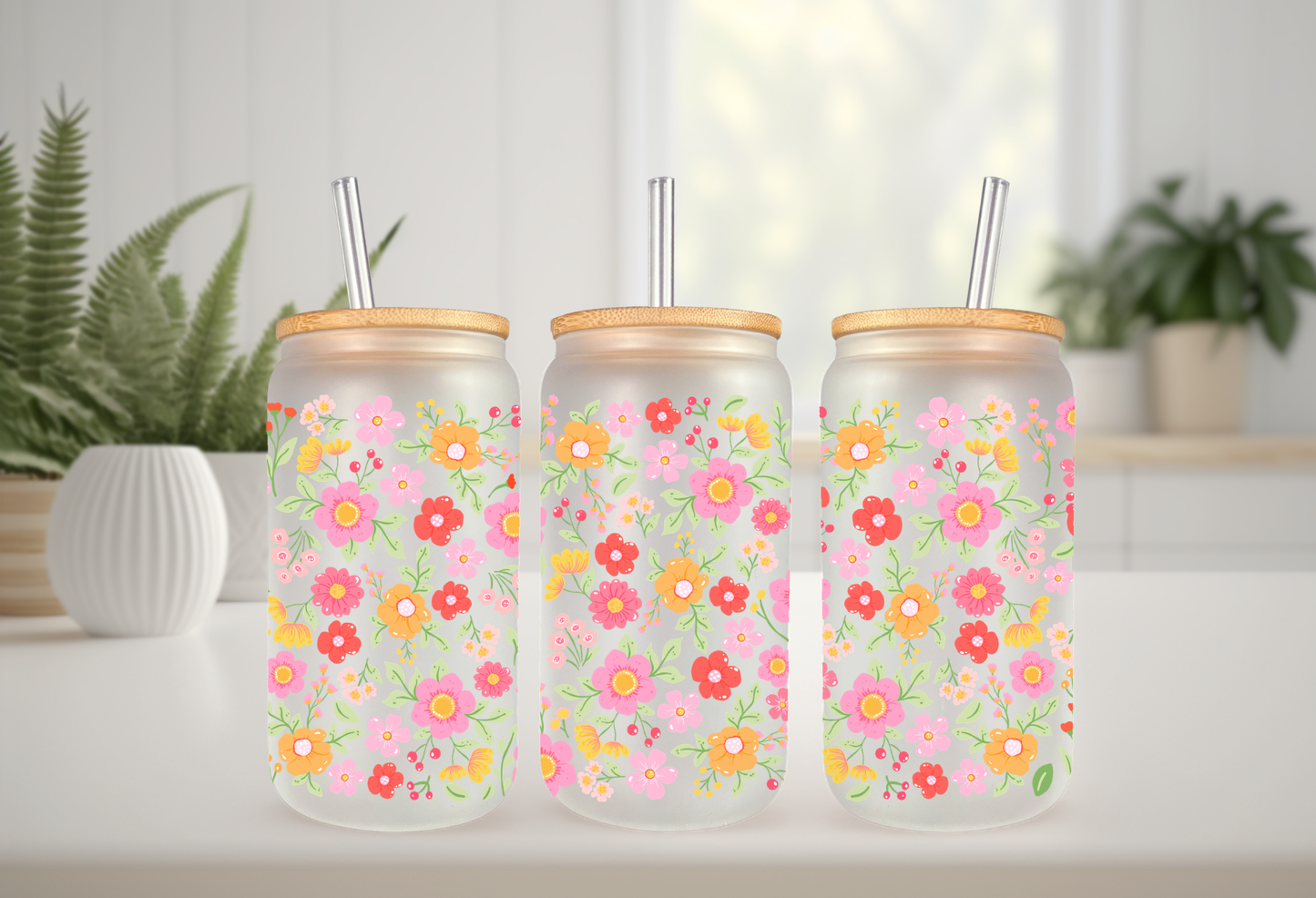 MOCKUP OF A 16oz frosted can glass wrap featuring a retro groovy floral design with bright pink, red, and yellow daisies on a clear background.