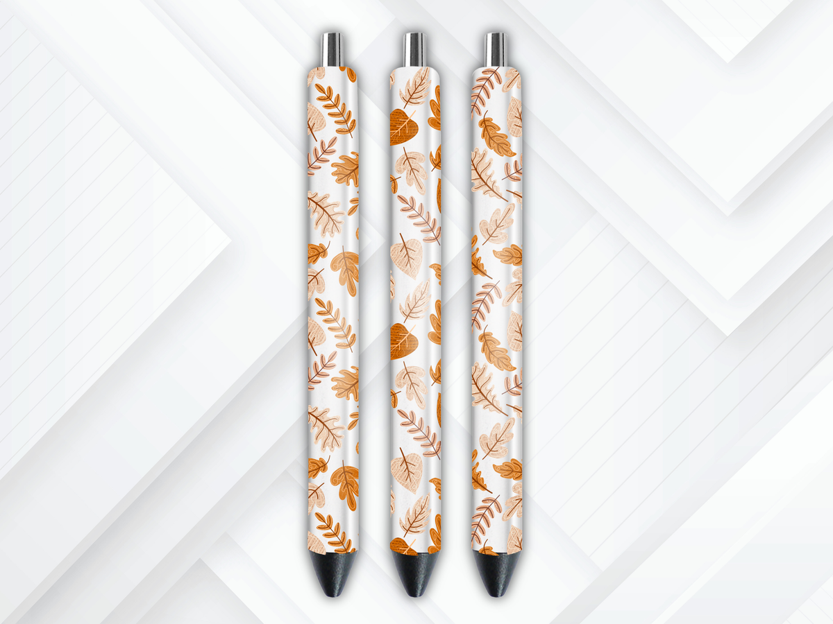 Pen wrap mockup featuring three white gel pens decorated with falling autumn leaves and maple foliage UV DTF transfers.