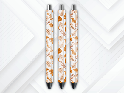Pen wrap mockup featuring three white gel pens decorated with falling autumn leaves and maple foliage UV DTF transfers.