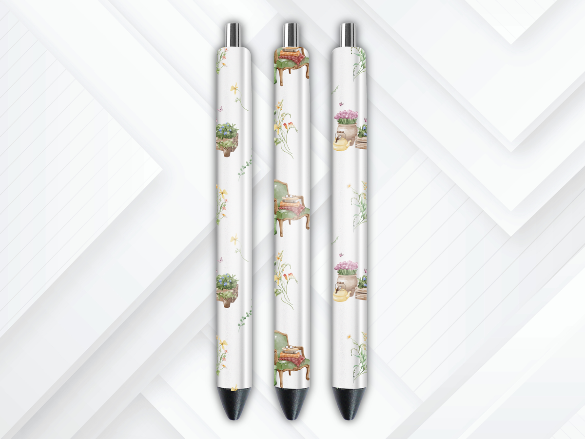 Pen wrap mockup featuring three white gel pens decorated with vintage reading armchairs, stacks of books, and potted botanical plants.