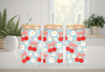 MOCKUP OF A 16oz can glass wrap featuring a trendy summer design with bright red cherries and red coquette bows over a light blue and white checkered background.
