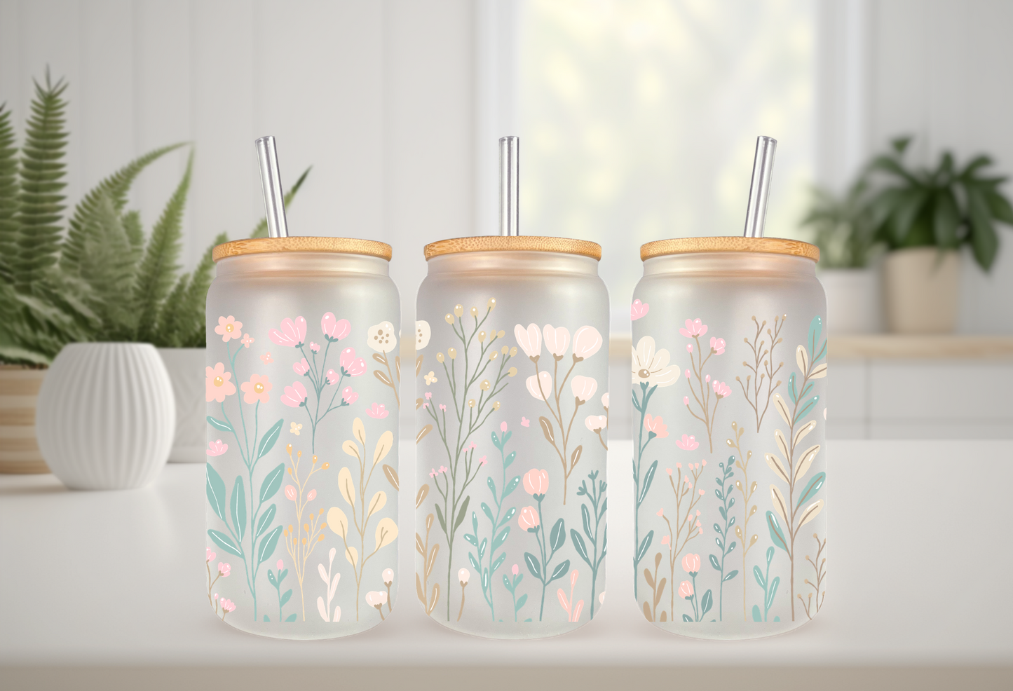 Mockup of 16oz can glass wrap featuring delicate pastel wildflowers, pink daisies, blue blossoms, and green leaves on a clear background.