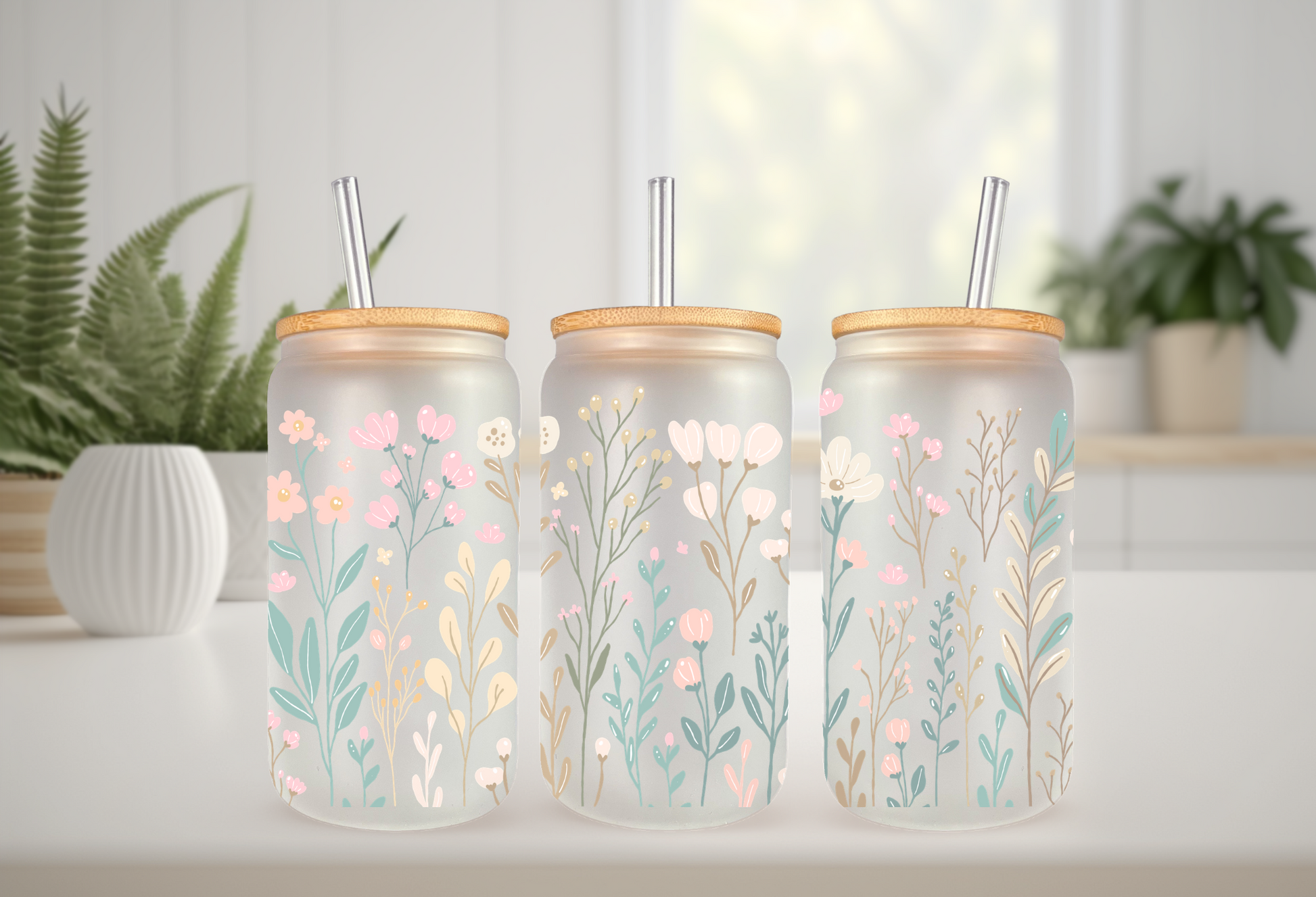 Mockup of 16oz can glass wrap featuring delicate pastel wildflowers, pink daisies, blue blossoms, and green leaves on a clear background.