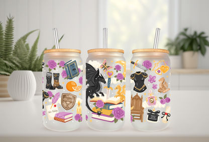 A mockup of three frosted 16oz glass cans with bamboo lids and straws, showcasing UV DTF transfers with bookish themes, dragons, and floral accents against a white background with green leaves