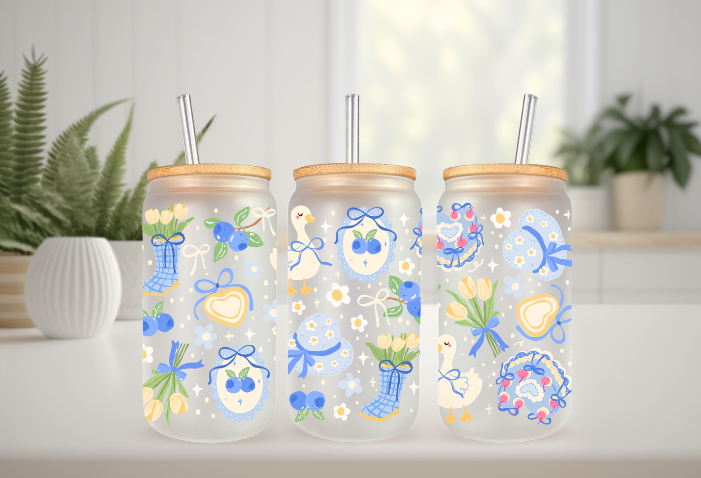 16oz can glass wrap featuring a pastel spring design with white porch geese wearing blue coquette bows mixed with yellow tulips and scattered blueberries.

