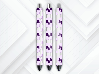 Pen wrap mockup featuring three white gel pens decorated with pastel purple skulls and bones UV DTF transfers.