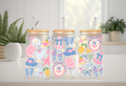 16oz can glass wrap featuring a pastel coastal design with pink and blue coquette bows, beach umbrellas, a vintage radio, and a Stay Salty motel key tag.