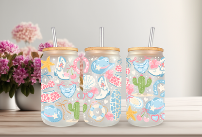 MOCKUP OF 16oz can glass wrap featuring white cowboy boots, a teal cowboy hat, cacti, starfishes, and seashells on a clear background.