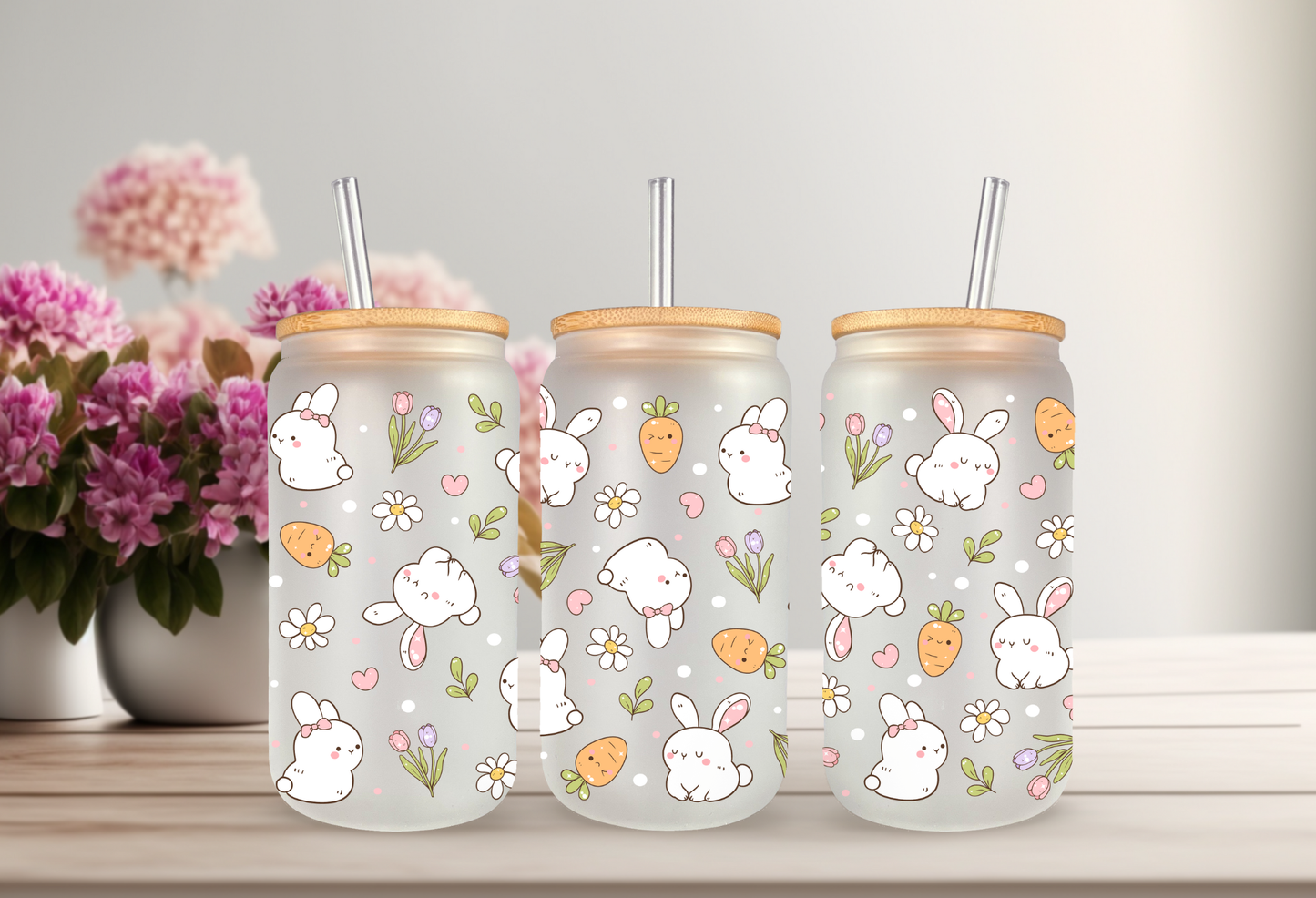 Product mockup of three 16oz glass cans featuring a Retro Bunny and Carrots UVDTF wrap with white bunnies, orange carrots, and spring flowers
