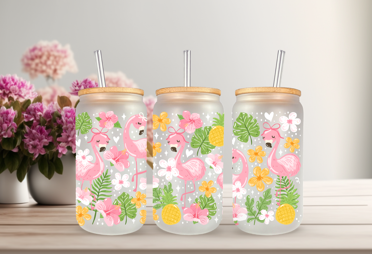 16oz can glass wrap featuring pink flamingos with polka dot bows, tropical pineapples, pink hibiscus, and green palm leaves on a clear background.