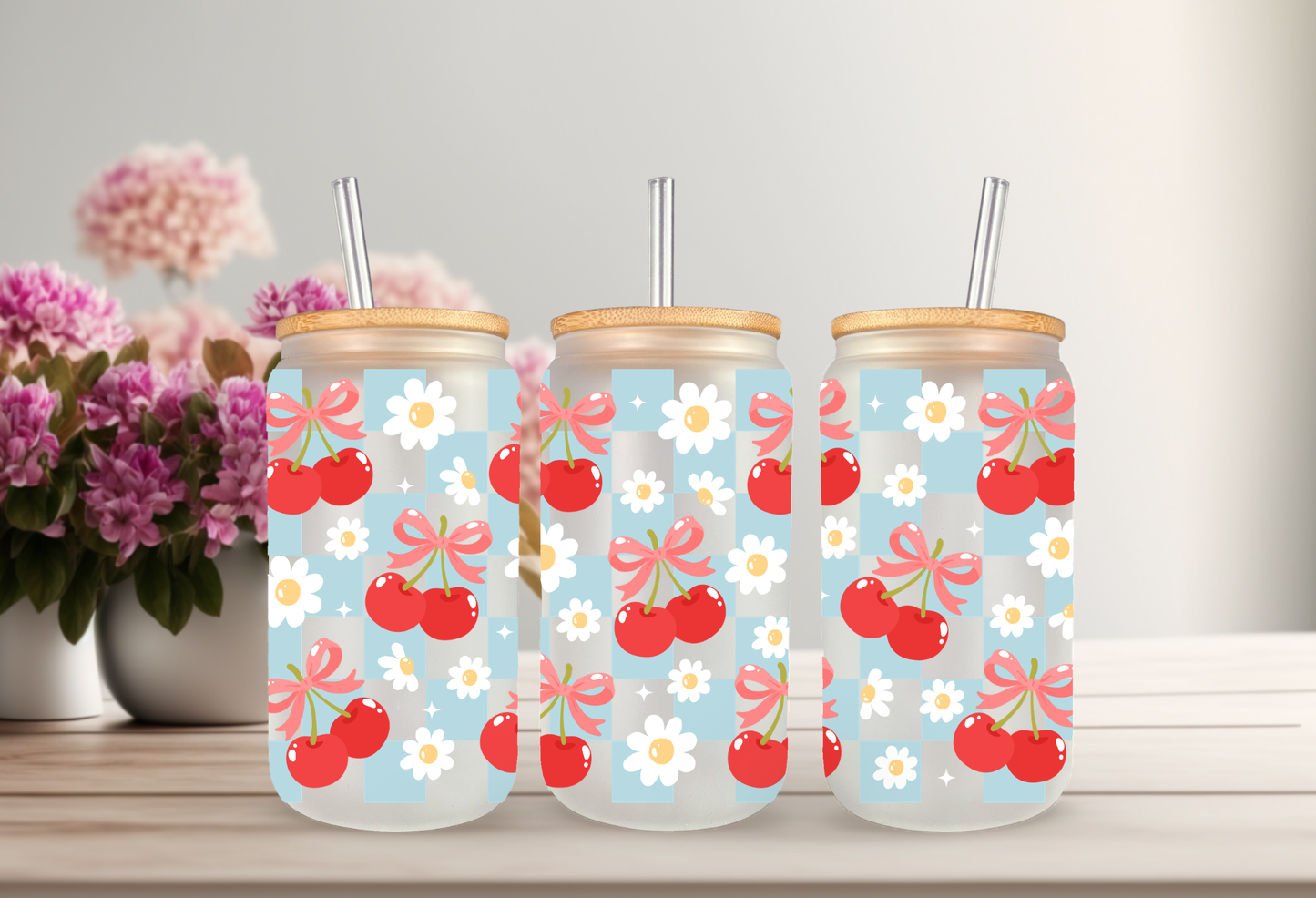 MOCKUP OF A 16oz can glass wrap featuring a trendy summer design with bright red cherries and red coquette bows over a light blue and white checkered background.