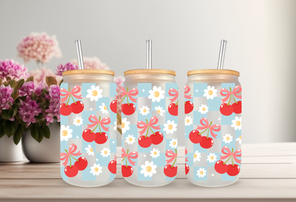 MOCKUP OF A 16oz can glass wrap featuring a trendy summer design with bright red cherries and red coquette bows over a light blue and white checkered background.