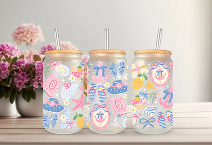 16oz can glass wrap featuring a pastel coastal design with pink and blue coquette bows, beach umbrellas, a vintage radio, and a Stay Salty motel key tag.