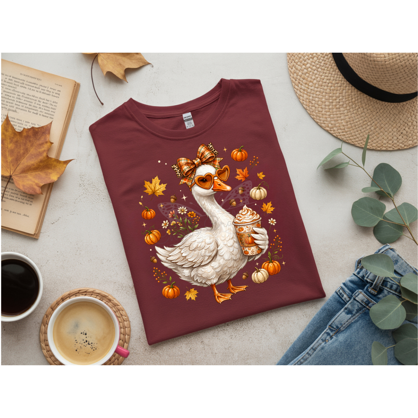 Ready to press DTF apparel transfer on a white t-shirt mockup featuring a white fall porch goose holding a pumpkin spice latte with autumn leaves
