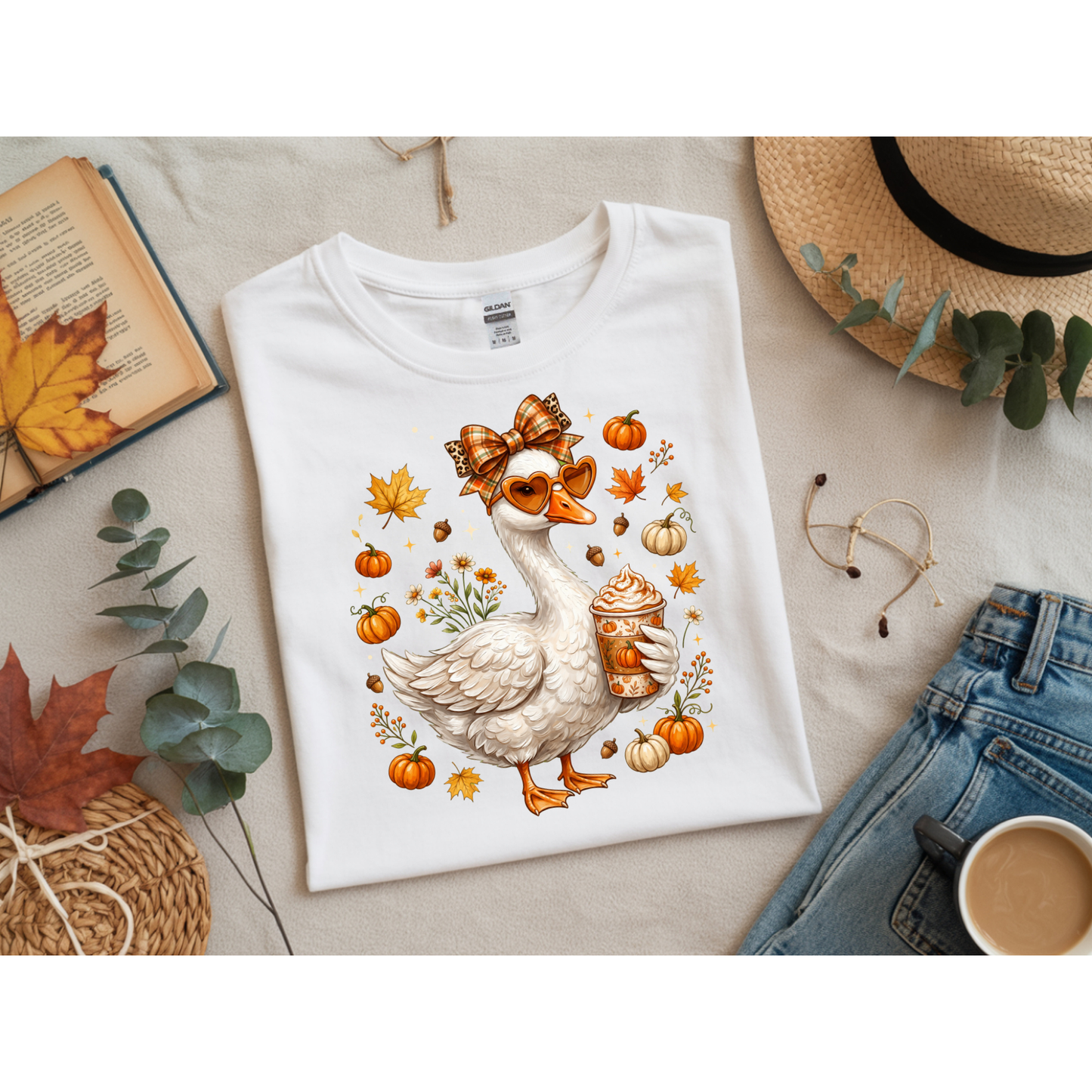 Ready to press DTF apparel transfer on a white t-shirt mockup featuring a white fall porch goose holding a pumpkin spice latte with autumn leaves