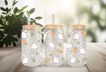 Product mockup of three 16oz glass cans featuring a Retro Bunny and Carrots UVDTF wrap with white bunnies, orange carrots, and spring flowers