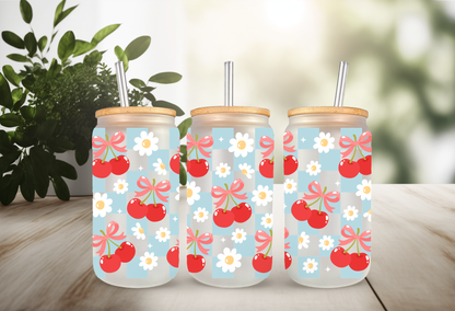 MOCKUP OF A 16oz can glass wrap featuring a trendy summer design with bright red cherries and red coquette bows over a light blue and white checkered background.