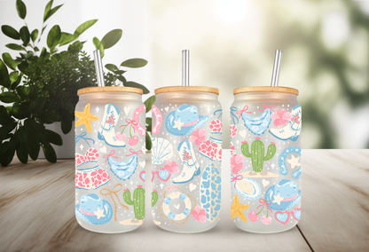MOCKUP OF 16oz can glass wrap featuring white cowboy boots, a teal cowboy hat, cacti, starfishes, and seashells on a clear background.