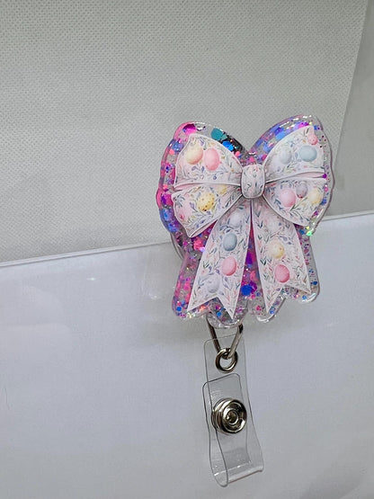 Glittery Easter Bow Badge Reel – Pastel Egg and Floral Design for Nurses, Teachers, and Professionals