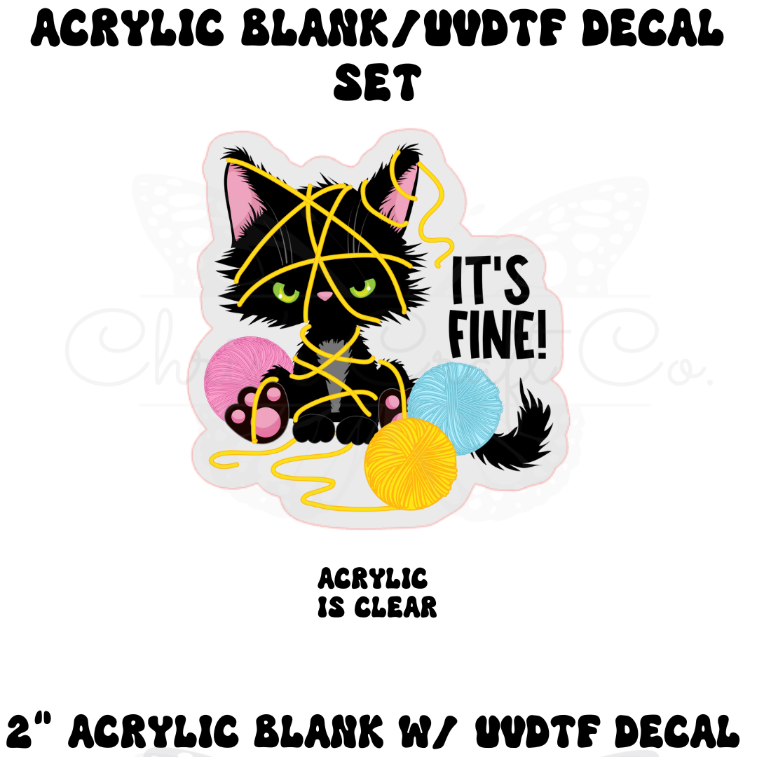  mockup of a Funny black cat in flames 'It's Fine' UVDTF decal sized for a 2 inch clear acrylic badge reel blank.