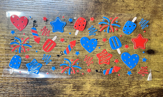 Colorful firework-themed stickers in a clear plastic bag on a wooden surface